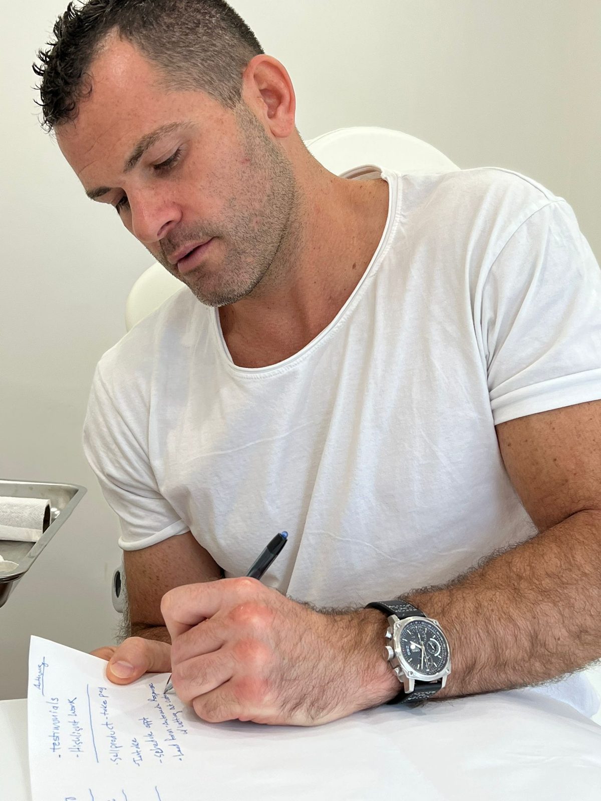 Trevor writing in a notebook