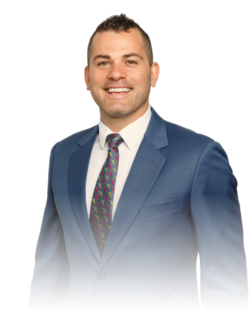 Trevor, smiling, in a blue suit